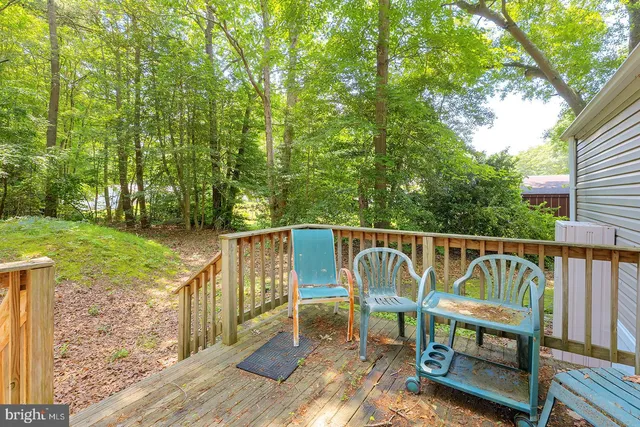 a view of a balcony with chairs and floor to ceiling window