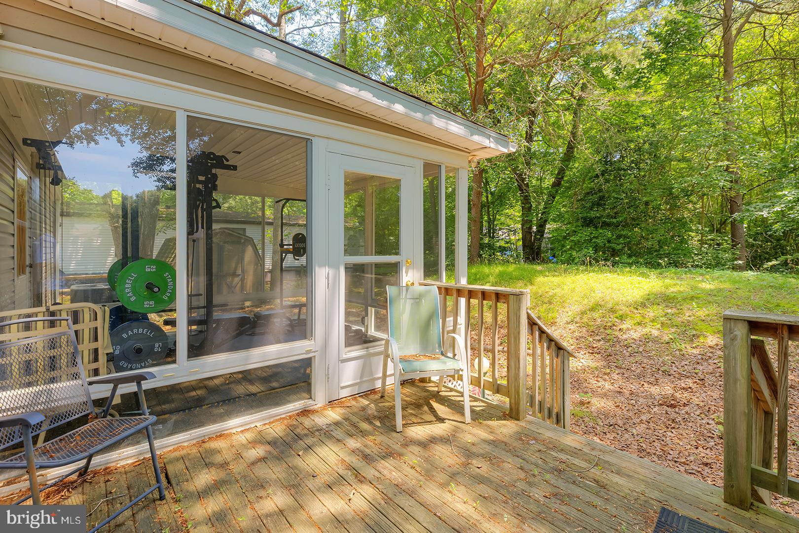 24119 Celtic Street Georgetown, DE 19947 - Photo 27 of 45 a view of a balcony with chairs and floor to ceiling window