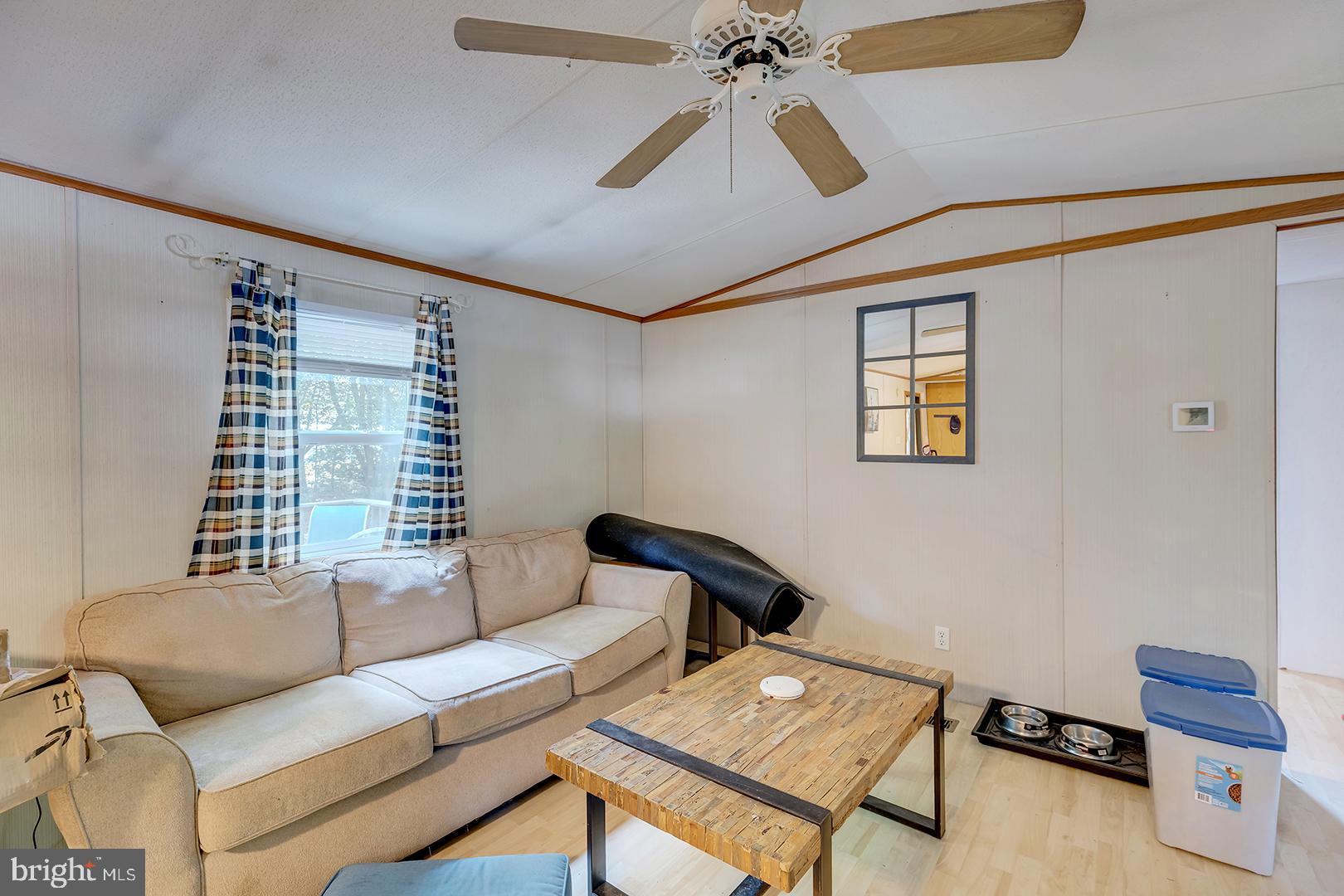 24119 Celtic Street Georgetown, DE 19947 - Photo 8 of 45 a living room with furniture and a window