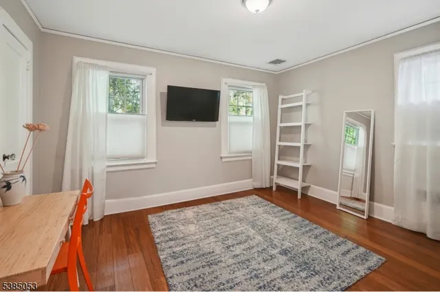 a view of a livingroom with wooden floor and a window