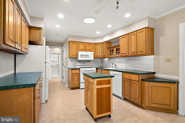 a kitchen with granite countertop a sink stainless steel appliances and cabinets