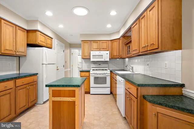 a kitchen with granite countertop cabinets stainless steel appliances and a sink
