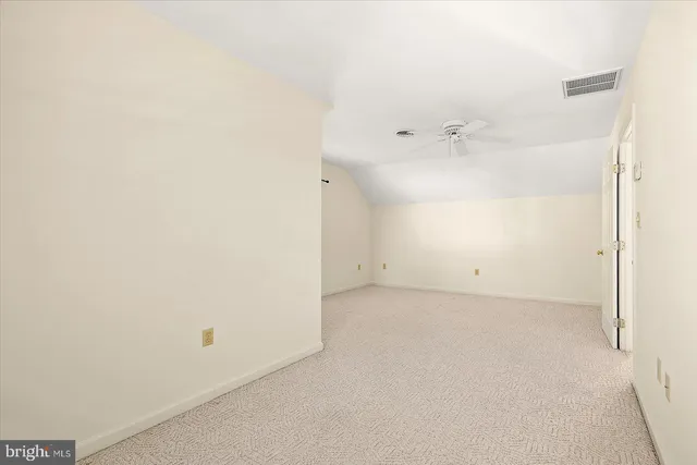 a view of a big room with a ceiling fan