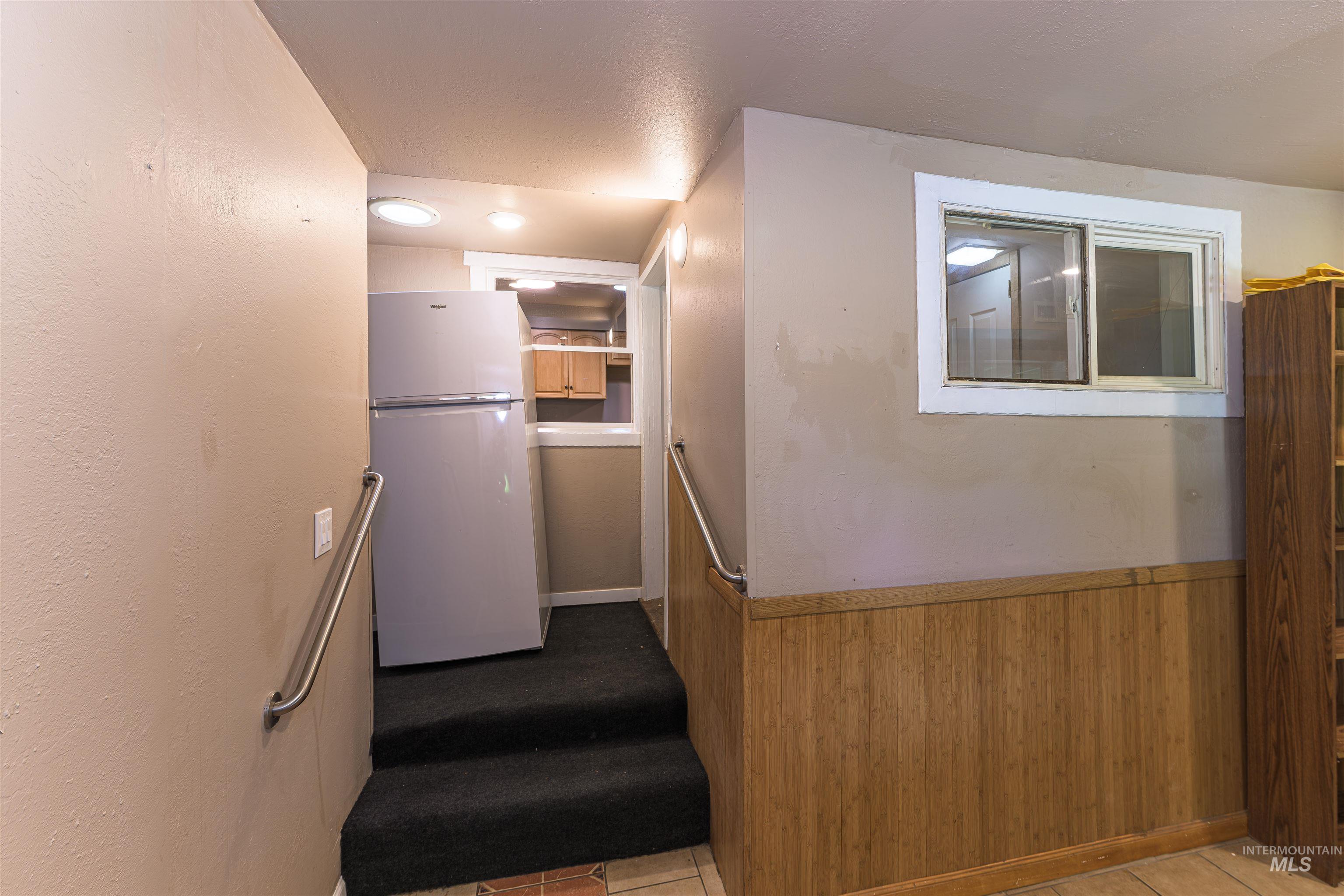 2003 North Cole Road Boise, ID 83704 - Photo 12 of 40 Stairs featuring wood walls and a wainscoted wall