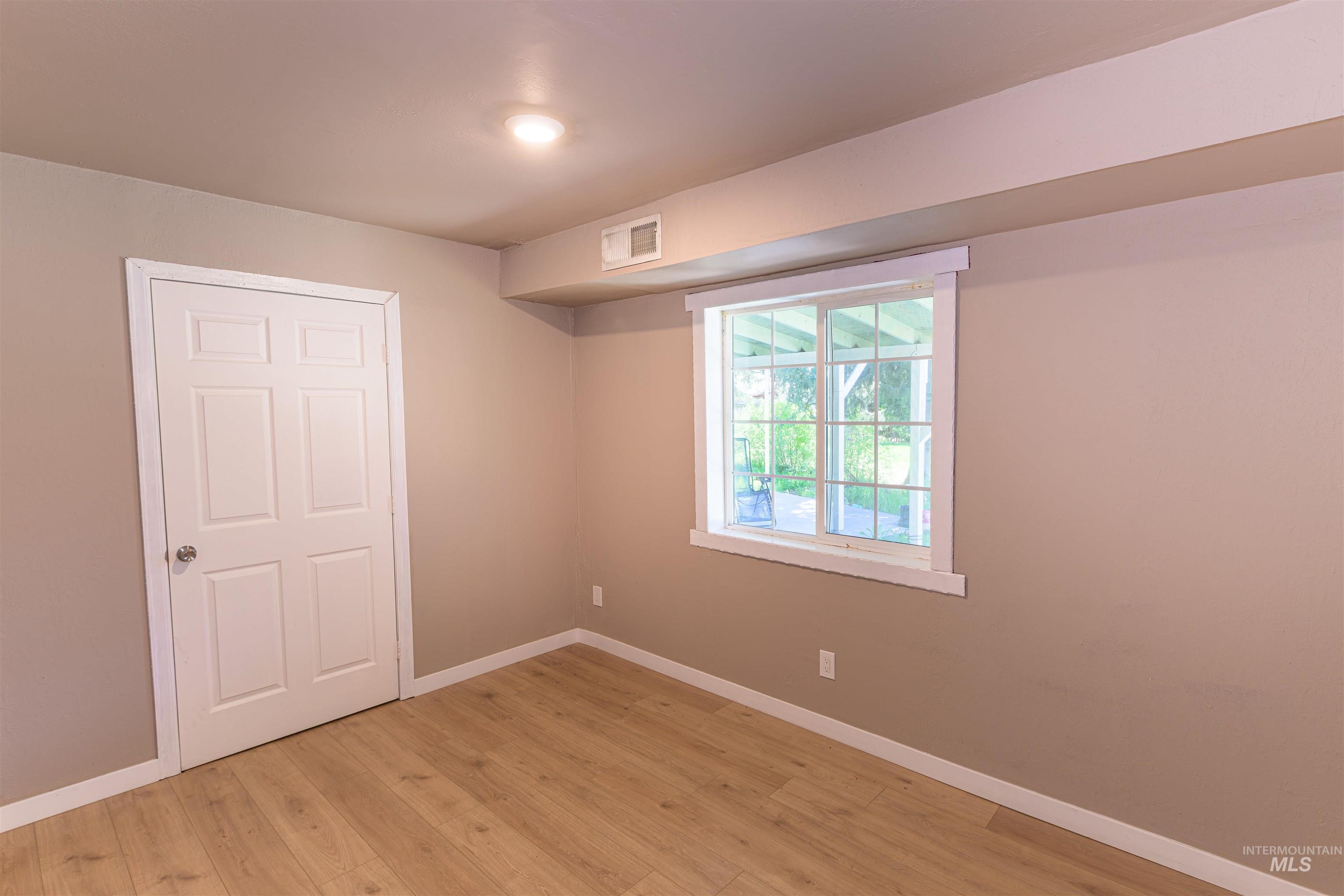 2003 North Cole Road Boise, ID 83704 - Photo 18 of 40 Unfurnished bedroom featuring light wood finished floors and baseboards