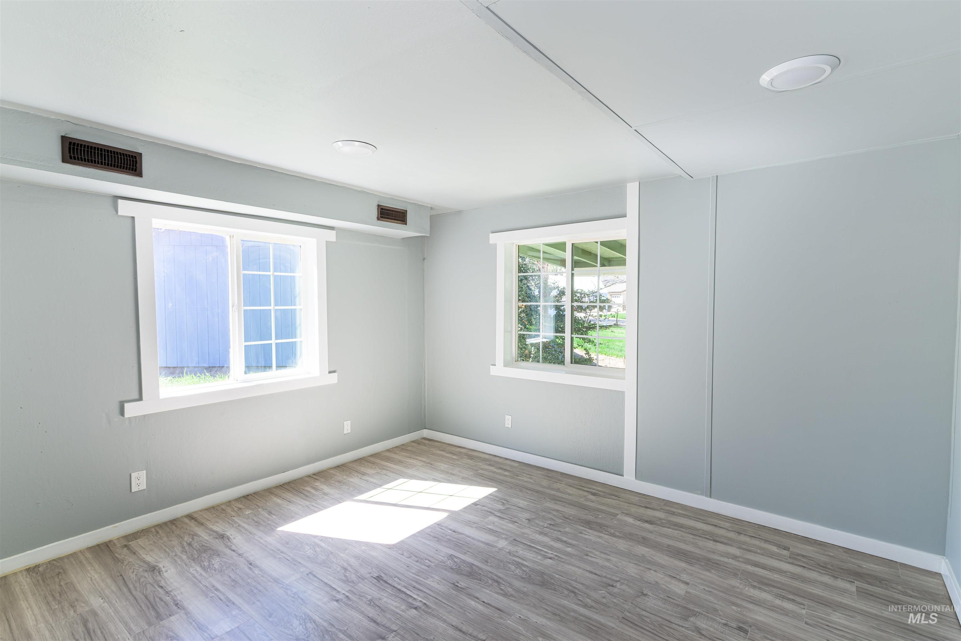 2003 North Cole Road Boise, ID 83704 - Photo 19 of 40 Spare room with light wood-style flooring and baseboards