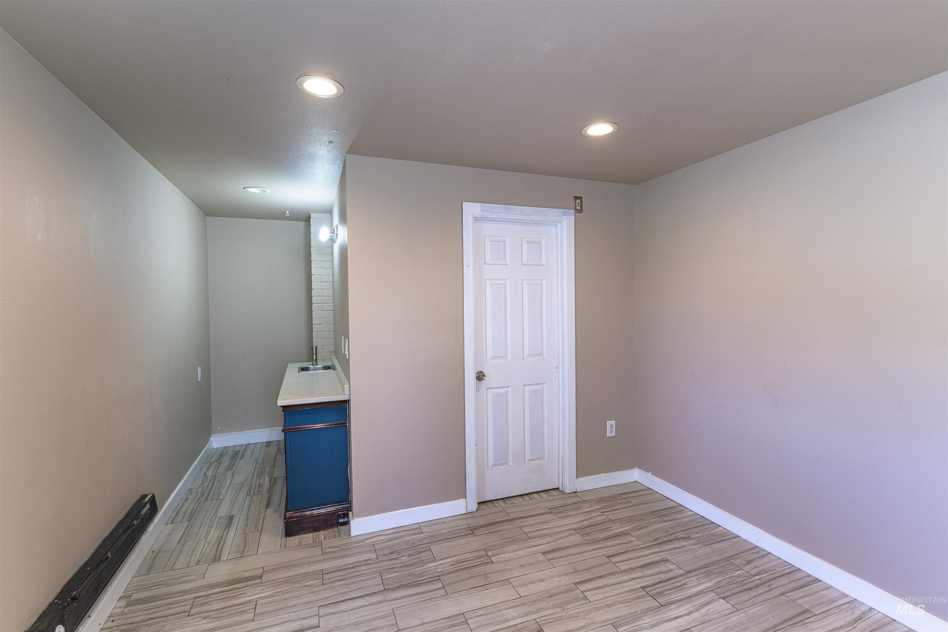 2003 North Cole Road Boise, ID 83704 - Photo 25 of 40 Empty room with wood tiled floors and recessed lighting