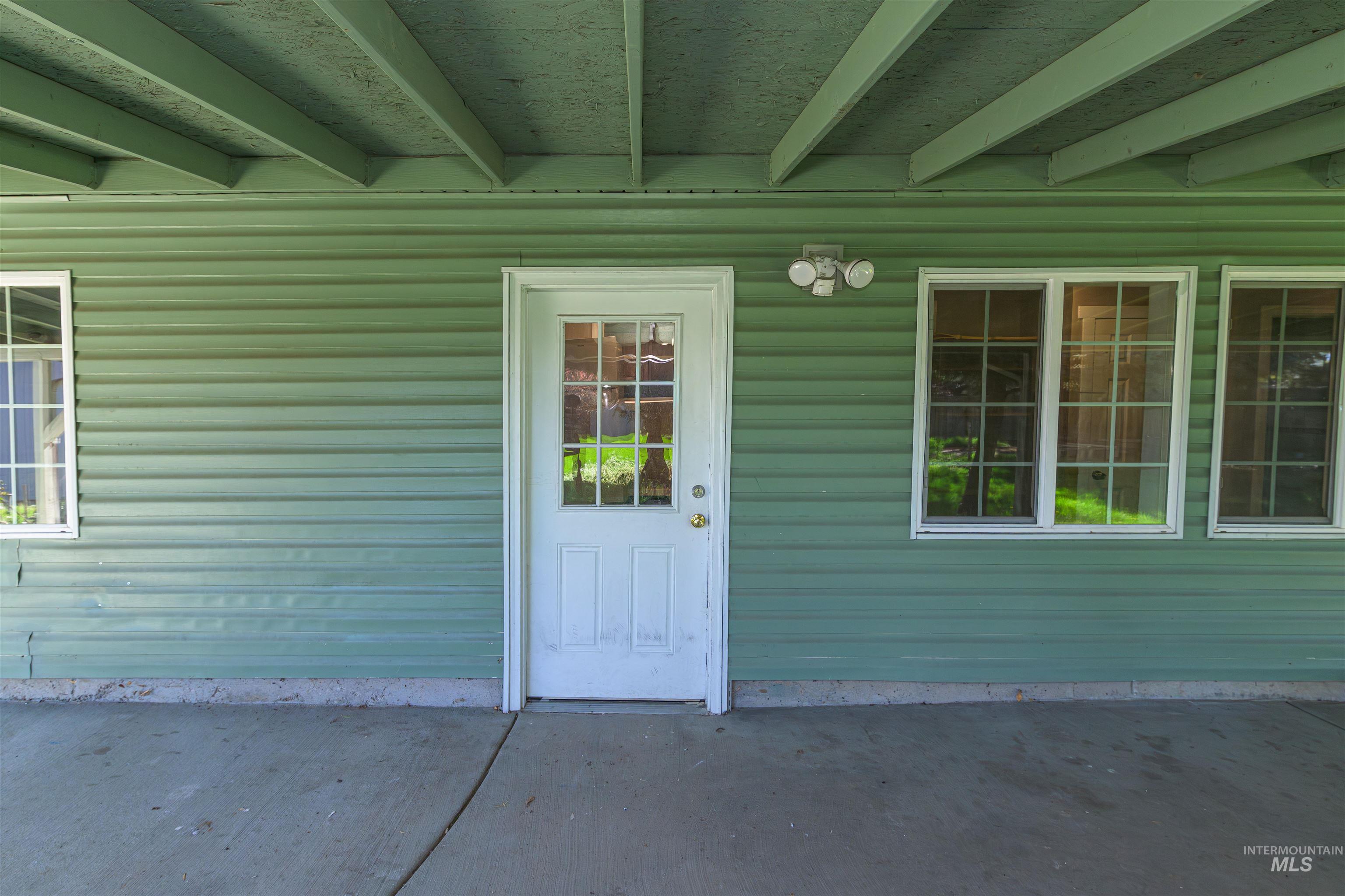 2003 North Cole Road Boise, ID 83704 - Photo 35 of 40 View of exterior entry featuring a patio and a metal roof