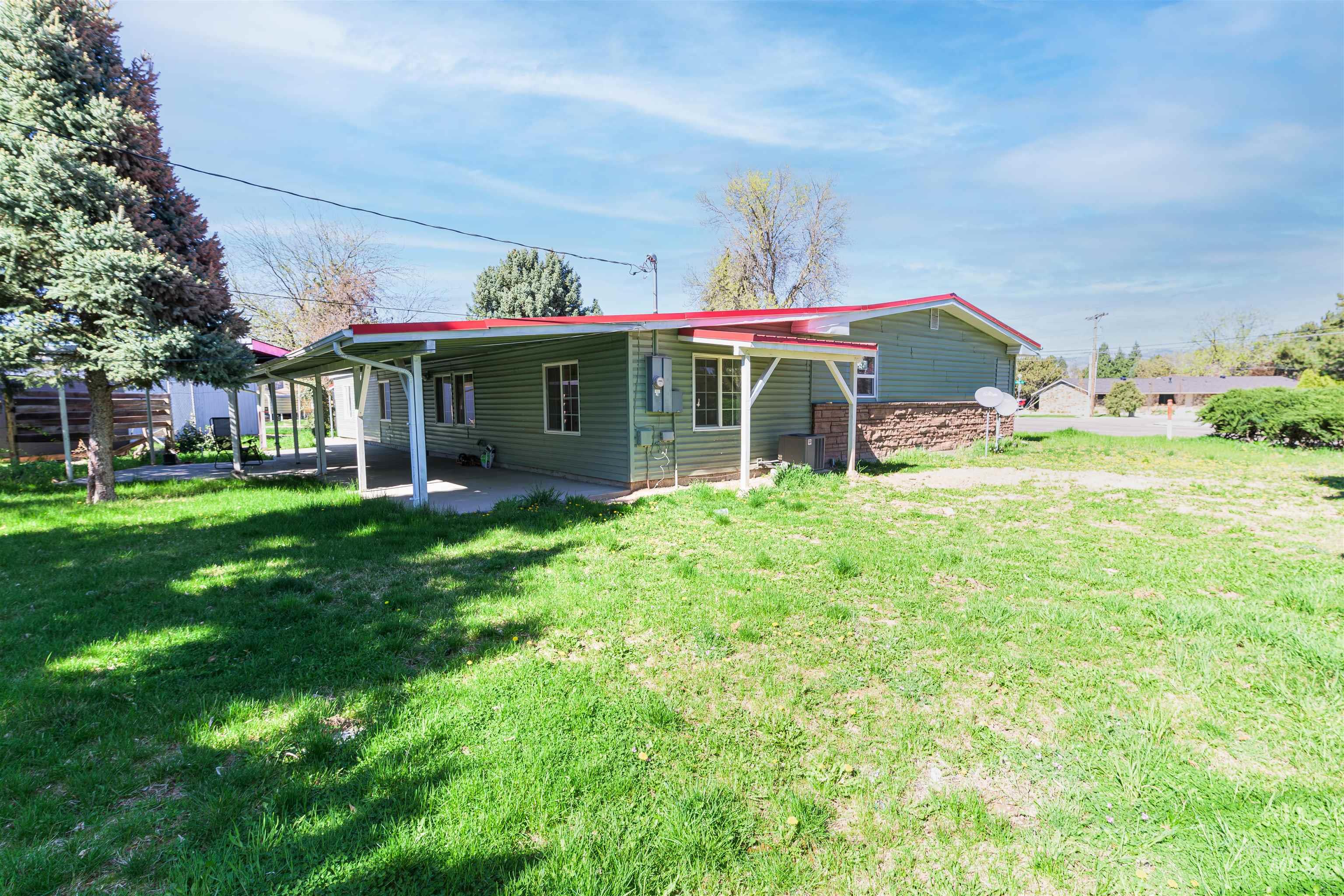 2003 North Cole Road Boise, ID 83704 - Photo 37 of 40 Back of property with a lawn and a patio