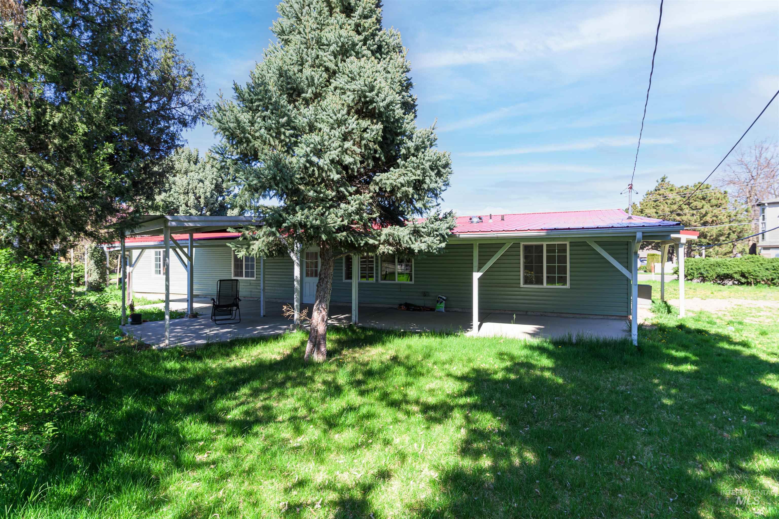 2003 North Cole Road Boise, ID 83704 - Photo 40 of 40 Rear view of property with a patio, a yard, and a metal roof
