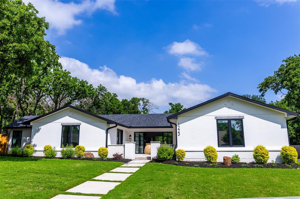 a front view of house with yard and green space