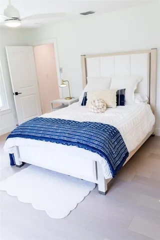 a bedroom with a bed and a lamp