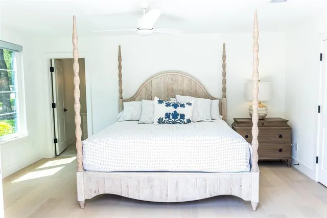 a bedroom with a bed and a chandelier