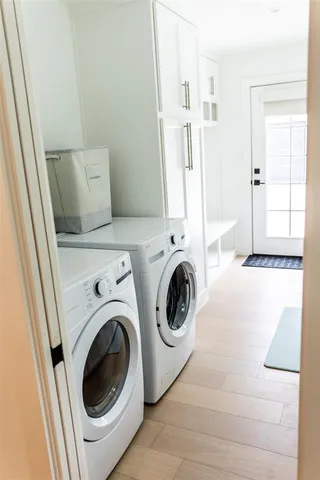 a view of a hallway with washer and dryer