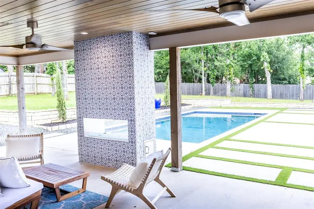 a living room with furniture and a floor to ceiling window