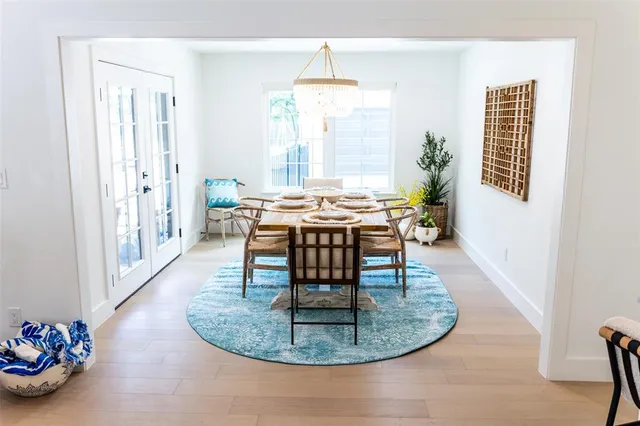 a dining room with furniture a potted plant and a chandelier