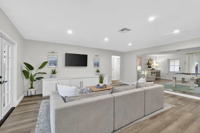 a living room with furniture and a wooden floor