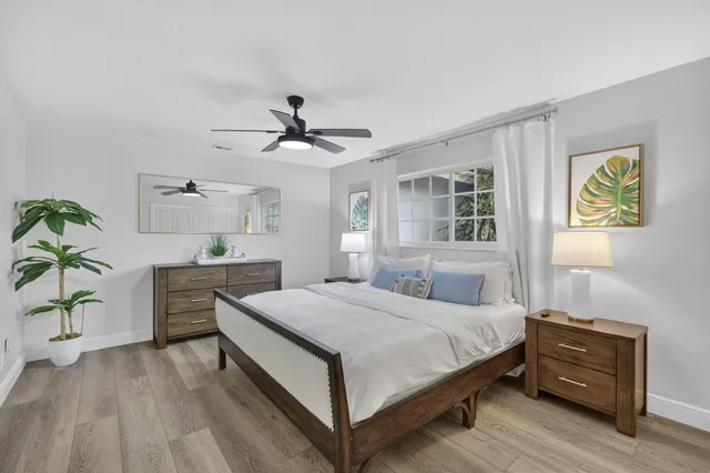 a bedroom with a large bed and a flat tv screen