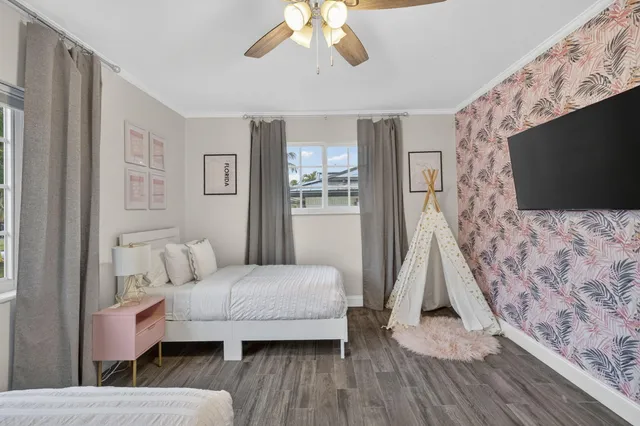 a view of a room with wooden floor and white walls