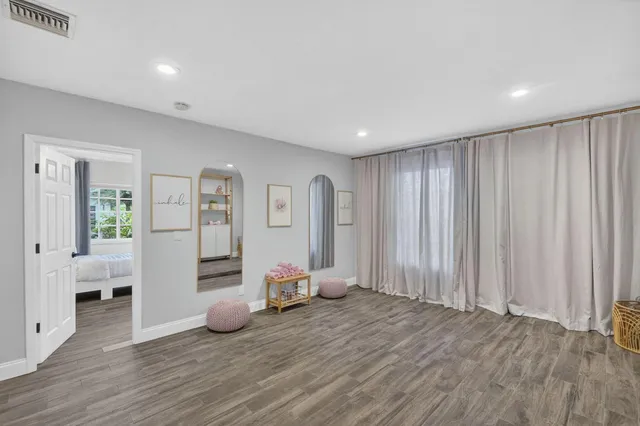 a bathroom with a granite countertop sink a toilet and a mirror