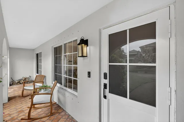 a view of a hallway with furniture and front door