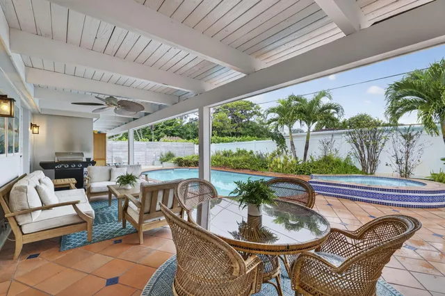 a view of a house with swimming pool and sitting area