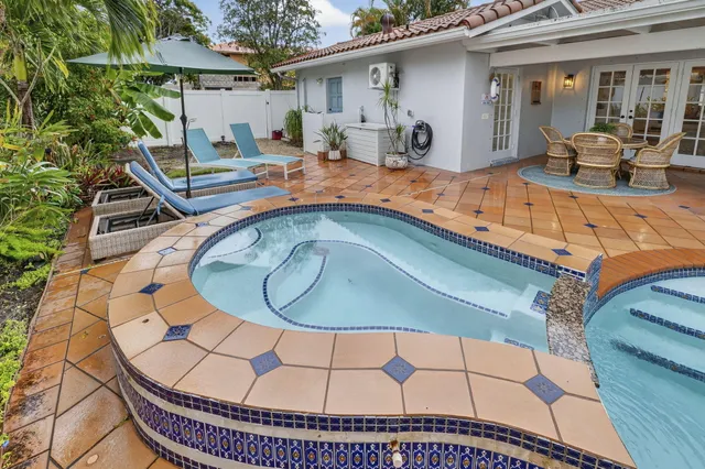 a aerial view of a house with a yard and a fountain