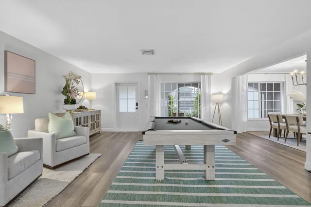 a spacious bedroom with furniture and wooden floor