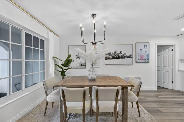 a dining room with furniture and wooden floor
