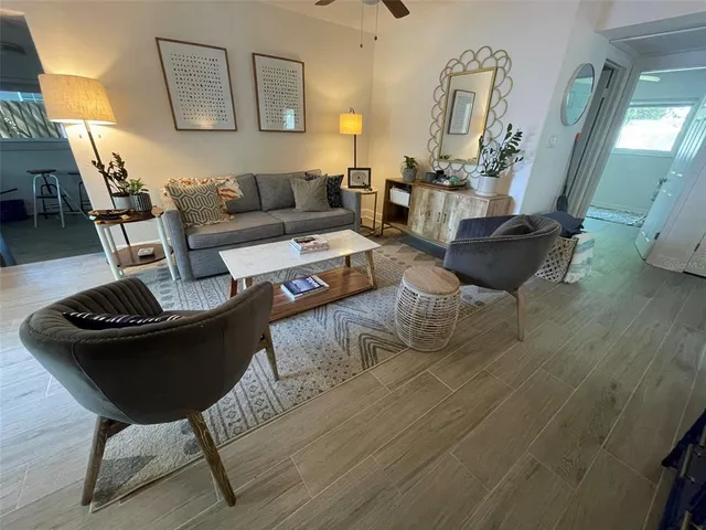 a living room with furniture and wooden floor