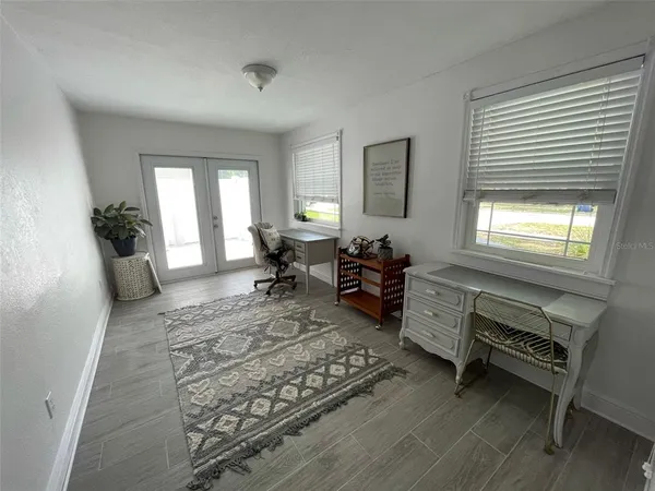 a living room with furniture rug and window