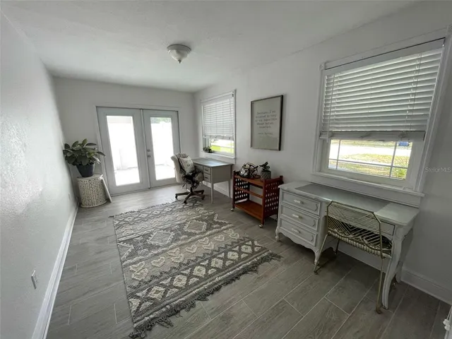 a living room with furniture rug and window