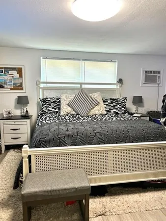 a bedroom with a bed and a window