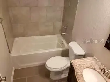 a white toilet sitting next to a bath tub