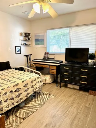 a bedroom with a bed and flat screen tv