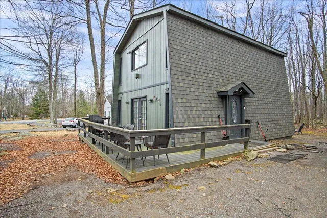 a view of a house with a yard and wooden fence