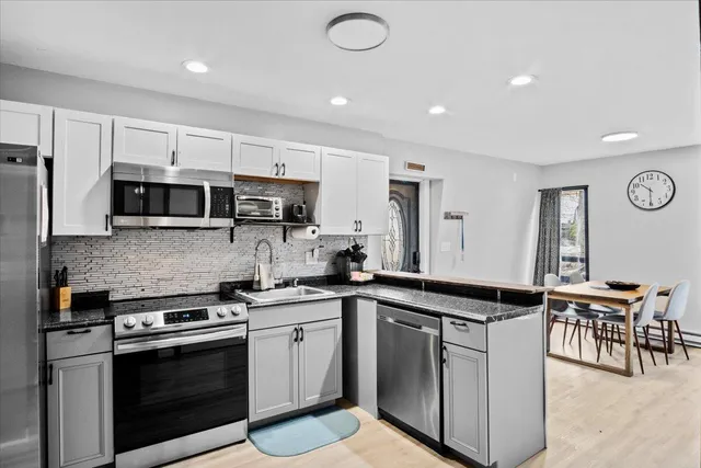a kitchen with a sink stove and microwave
