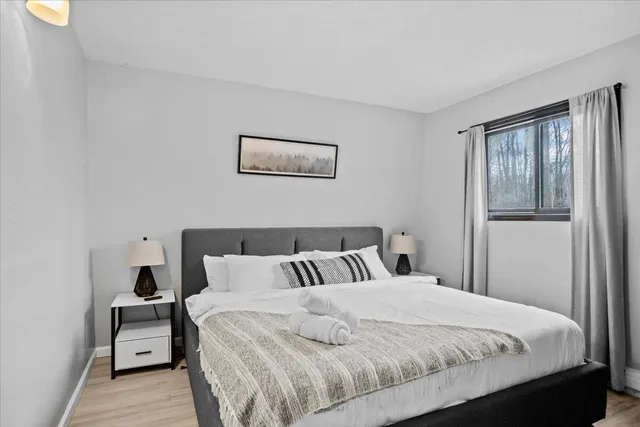 a bedroom with a bed and balcony