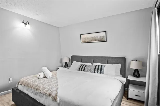 a bedroom with a bed and a lamp