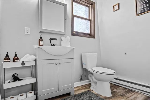 a bathroom with a sink toilet and a window