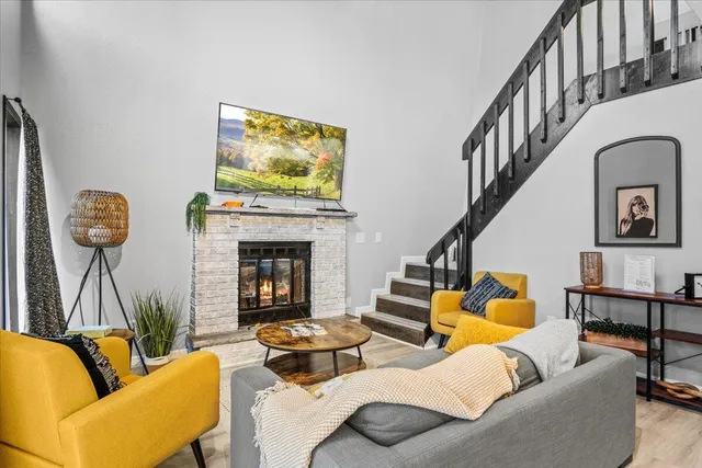 a living room with furniture and a floor to ceiling window