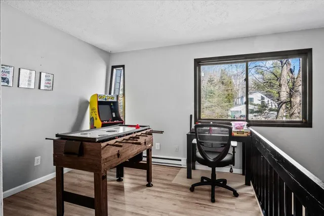 a view of a workspace with furniture and a window