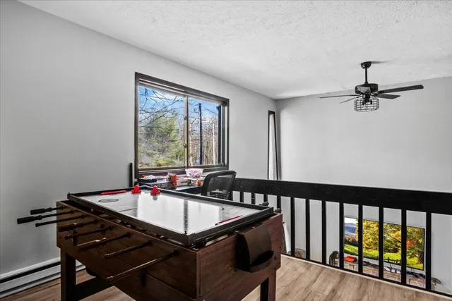 a bedroom with a bed and a painting on the wall