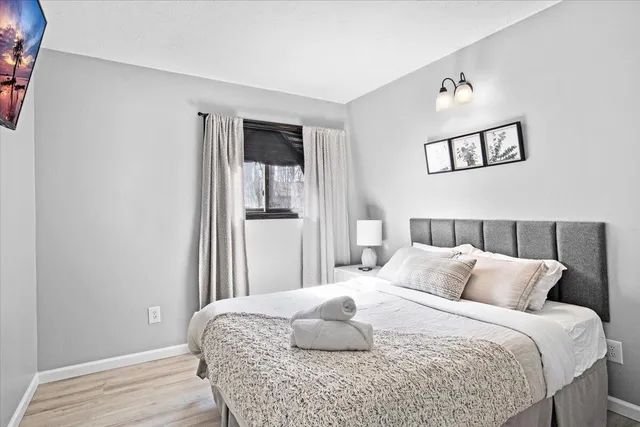 a bedroom with a bed and a large mirror