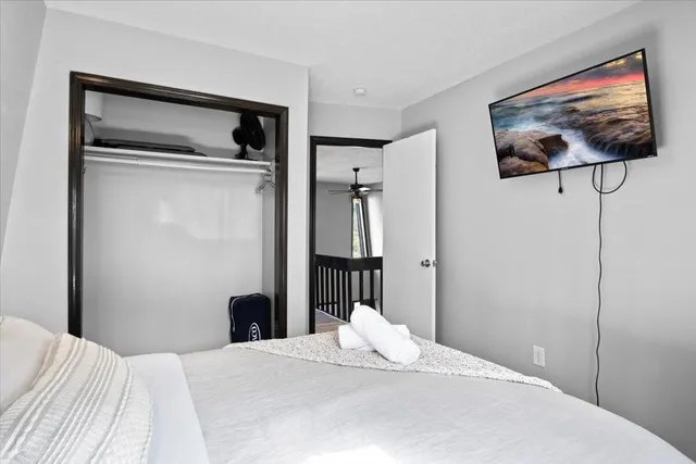 a bedroom with a bed and a tv