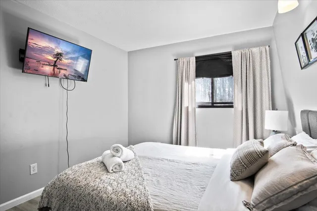 a bedroom with a bed and a chandelier