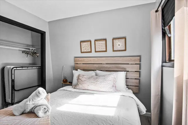 a bedroom with a bed and a flat screen tv