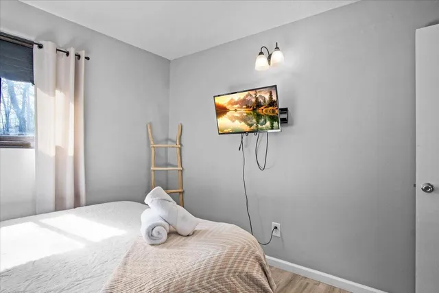 a brick house with tree in front of it