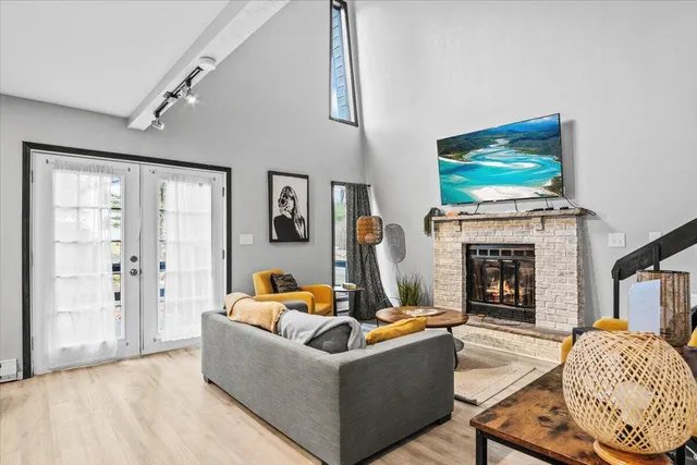 a living room with fireplace furniture and a flat screen tv