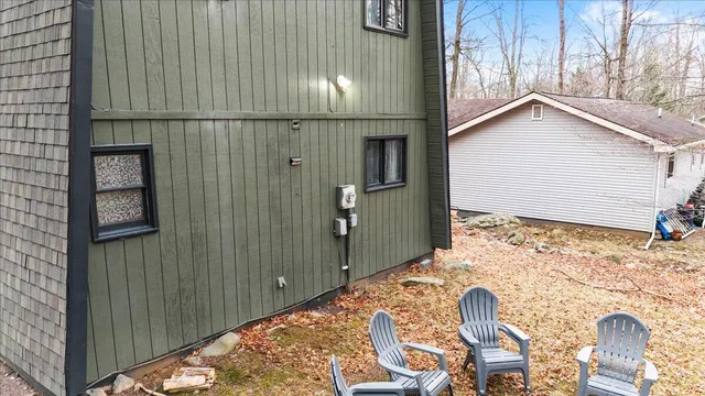a backyard of a house with table and chairs